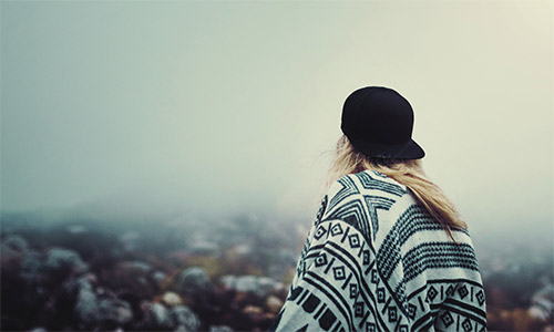 A photo of a woman looking off into the distance.