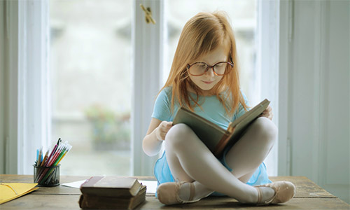 A photo of a child reading a book.