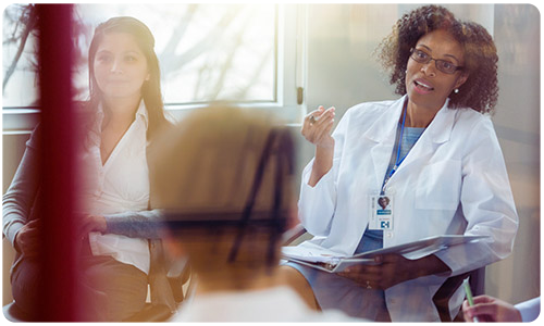 A photo of a nurse in a meeting.