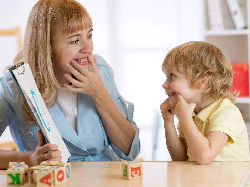Teacher and child leaning abc